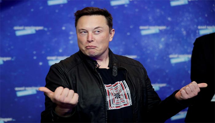 SpaceX owner and Tesla CEO Elon Musk grimaces after arriving on the red carpet for the Axel Springer award, in Berlin, Germany, December 1, 2020. REUTERS/Hannibal Hanschke/Pool