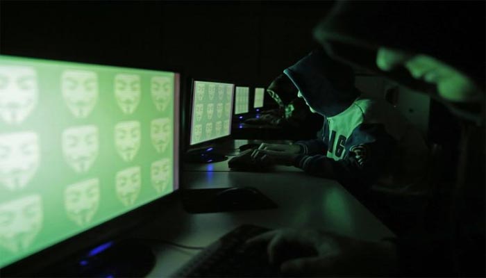 People pose in front of a display showing the word cyber in binary code, in this picture illustration taken in Zenica December 27, 2014. —Reuters/Dado Ruvic