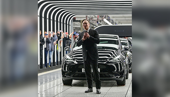 German Chancellor Olaf Scholz, Brandenburg Premier Dietmar Woidke and Elon Musk attend the opening ceremony of the new Tesla Gigafactory for electric cars in Gruenheide, Germany, March 22, 2022. — Reuters