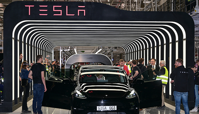 Elon Musk hands over a Model Y car to a customer during the opening ceremony of the new Tesla Gigafactory for electric cars in Gruenheide, Germany, March 22, 2022. — Reuters