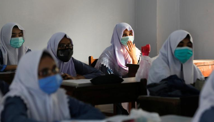 Students wear protective masks while maintaining safe distance as they attend a class as schools reopen amid the coronavirus disease (COVID-19) pandemic, in Karachi, Pakistan September 15, 2020. — Reuters