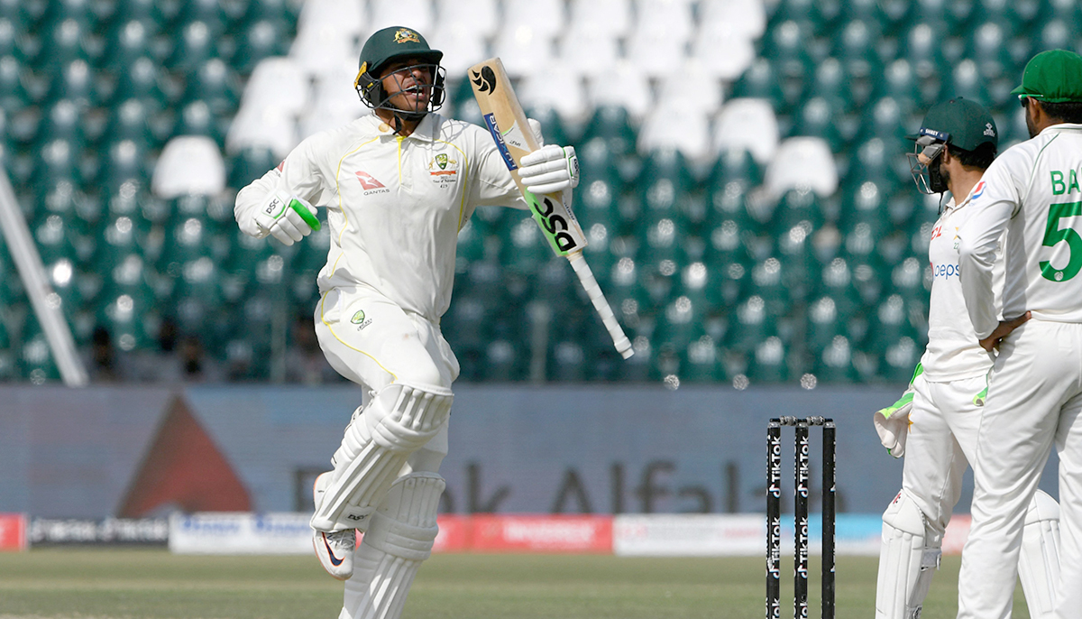 Australias Usman Khawaja celebrates after scoring a century (100 runs) during the fourth day of the third and final Test cricket match between Pakistan and Australia at the Gaddafi Cricket Stadium in Lahore on March 24, 2022. — AFP