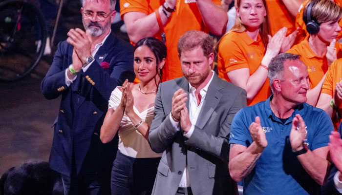 Prince Harry and his wife Meghan Markle clap during the opening ceremony of the Invictus Games in The Hague on April 16, 2022- AFP