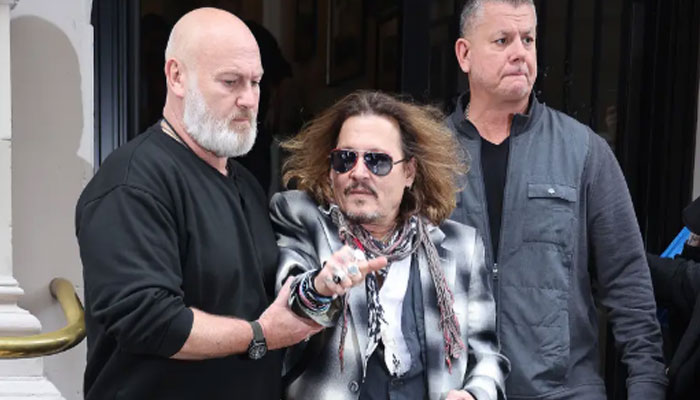 Johnny Depp distressed as security escorts him out of Birmingham hotel