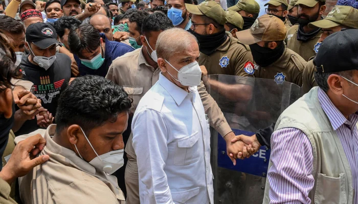 Shehbaz Sharif (C) arrives at the High Court in Lahore on July 16, 2020. — AFP/File