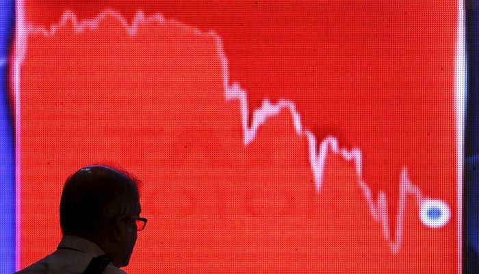 A representational image of a person looking at the graph of the stock. — Reuters/File