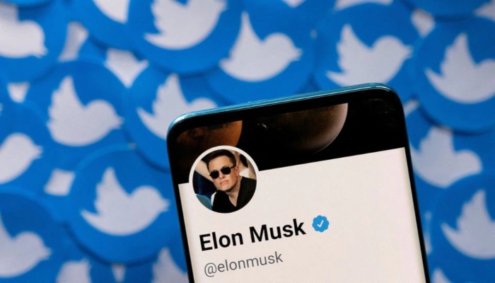 Elon Musks Twitter profile is seen on a smartphone placed on printed Twitter logos in this picture illustration taken April 28, 2022. — Reuters/File