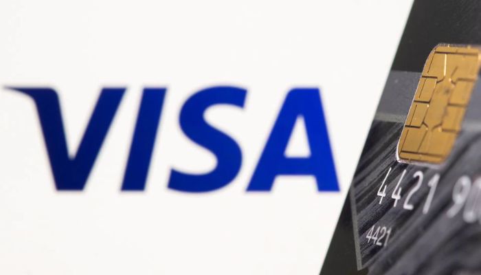 Credit card is seen in front of displayed Visa logo in this illustration taken, July 15, 2021. — Reuters