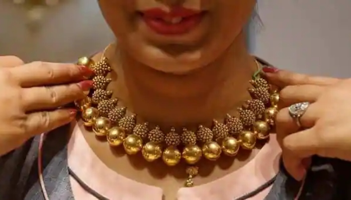 The picture shows a woman wearing a gold necklace. — Reuters/File