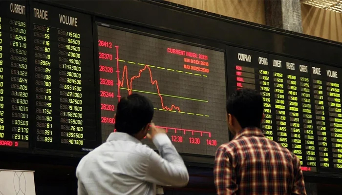 A representational image of investors looking at the digital stock board at the Pakistan Stock Exchange. — AFP/File