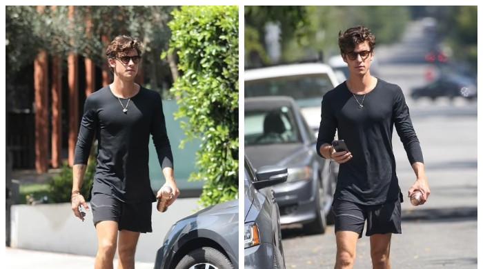 Shawn Mendes shows off his muscles in a form-fitting shirt as he grabs  coffee in West Hollywood