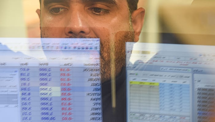 A stockbroker monitors the share prices during a trading session at the Pakistan Stock Exchange (PSX) in Karachi on June 24, 2022. — AFP