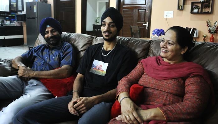 Indian pacer Arshdeep Singh with his parents in his home in Kharar, Chandigarh. — Espncricinfo/File