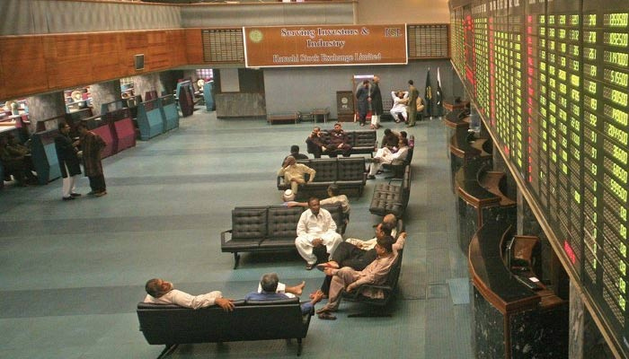 Investors can be seen sitting in the main hall of the Pakistan Stock Exchange. — AFP/File