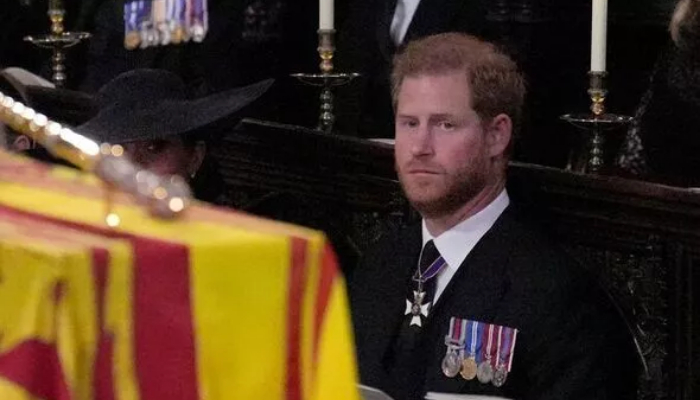 Prince Harry’s face spells sorrow as he watches Queen being lowered in grave