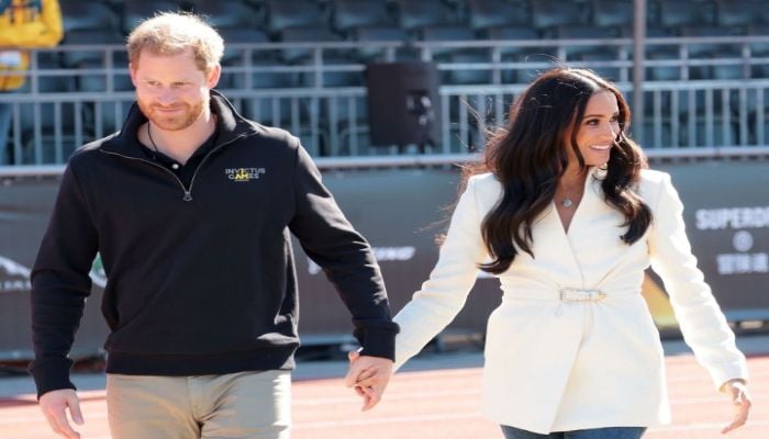 Prince Harry and Meghan Markle seen dancing at music concert