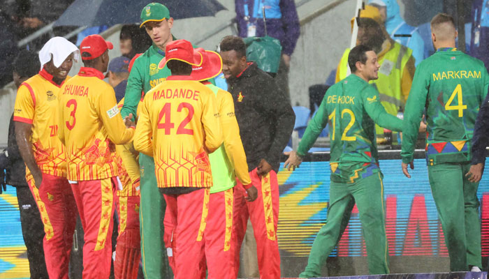 South Africa and Zimbabwe players shake hands after the play being called off during the ICC mens Twenty20 World Cup 2022 cricket match between South Africa and Zimbabwe at Bellerive Oval in Hobart on October 24, 2022. — AFP