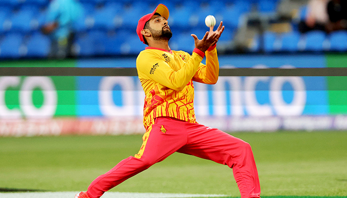 Zimbabwes Sikandar Raza takes a catch to dismiss Scotlands Michael Jones during the ICC mens T20 World Cup 2022 cricket match between Scotland and Zimbabwe at Bellerive Oval in Hobart on October 21, 2022. — AFP