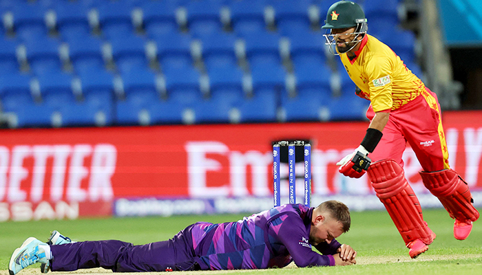 Zimbabwes Sikandar Raza (right) runs around Scotlands Mark Watt during the ICC mens T20 World Cup 2022 cricket match between Scotland and Zimbabwe at Bellerive Oval in Hobart on October 21, 2022. — AFP