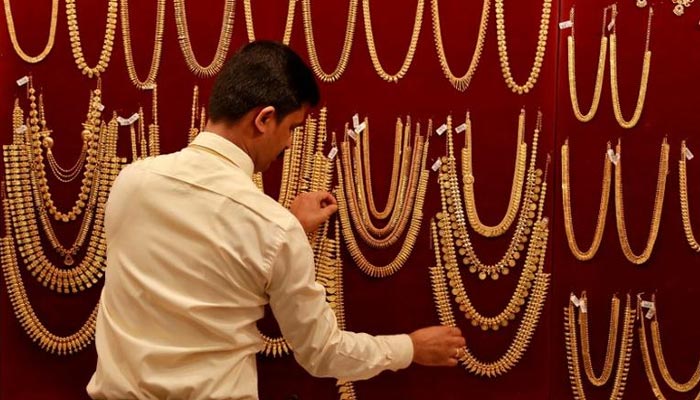 A representational image of a gold shop owner setting the jewellery. — Reuters/File