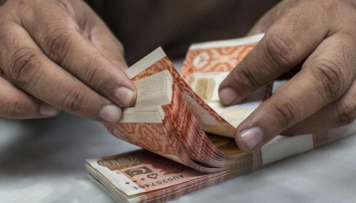 A currency dealer can be seen counting Rs 5000 notes.  — AFP/File