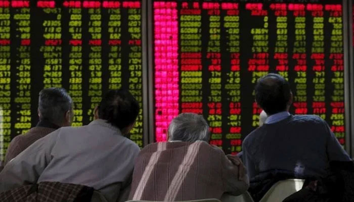 A group of Stockbrokers eye a trading screen at Pakistan Stock Exchange. — Reuters/File