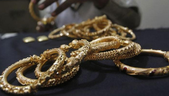 A goldsmith holds finished gold bangles at a workshop in Kolkata in this undated image. — Reuters