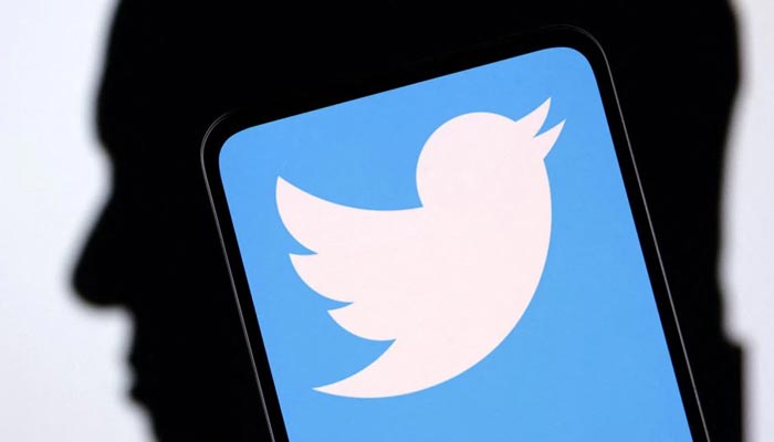 Twitter logo and Elon Musk silhouette are seen in this illustration taken, December 19, 2022. — Reuters