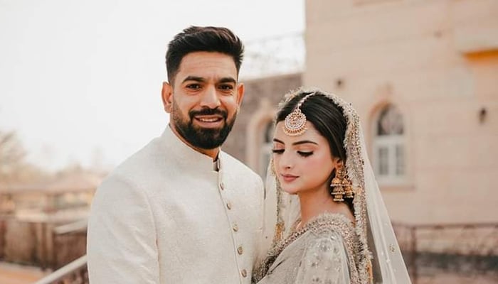 Pakistans star pacer Haris Rauf poses with his wife, Muzna Masood Malik, in Islamabad on December 24, 2022. — Instagram/pictroizzah