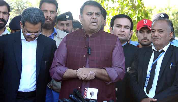 Senior PTI leader Fawad Chaudhry talking with media persons outside Election Commission Office. — INP