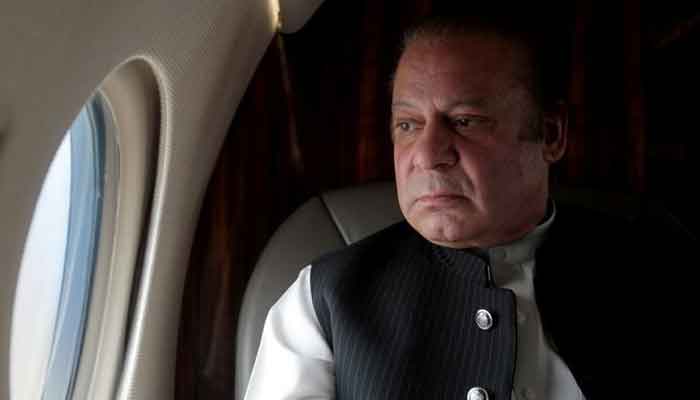 Former prime minister Nawaz Sharif looks out the window of his plane after attending a ceremony to inaugurate the M9 motorway between Karachi and Hyderabad, Pakistan February 3, 2017. — Reuters