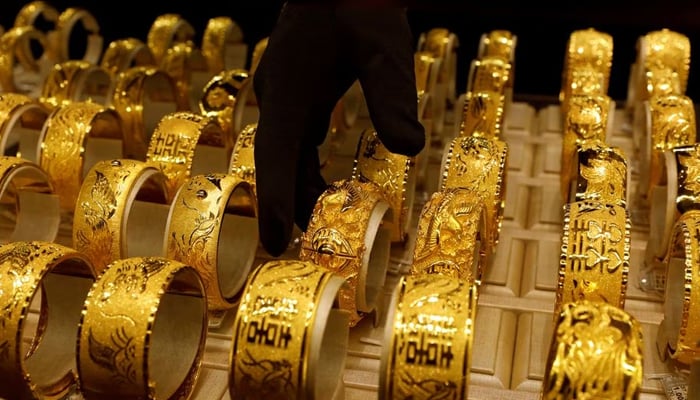 A salesperson arranges 24K gold bracelets. — Reuters/File