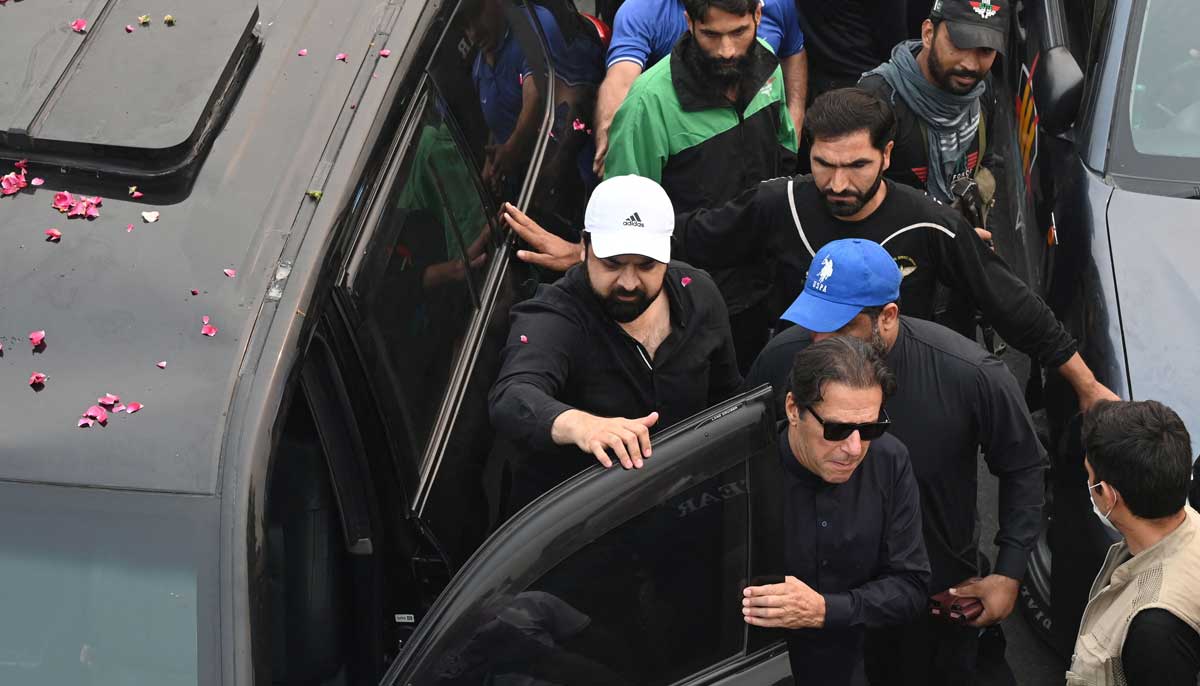 Pakistan´s former prime minister Imran Khan (C) arrives to join an anti-government march towards capital Islamabad, demanding early elections, in Gujranwala on November 1, 2022. — AFP