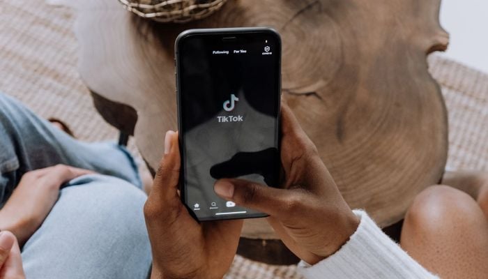 Person holding black android smartphone and using TikTok.— Pexels