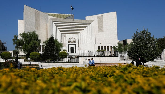 Two policemen walk past the Supreme Court. — Reuters/File