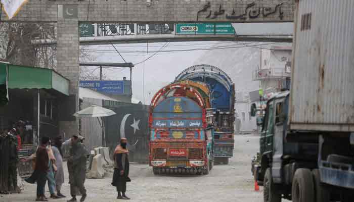 Goods carrier trucks cross into Pakistan at the zero point Torkham border crossing between Afghanistan and Pakistan, in Nangarhar province on February 25, 2023. — AFP