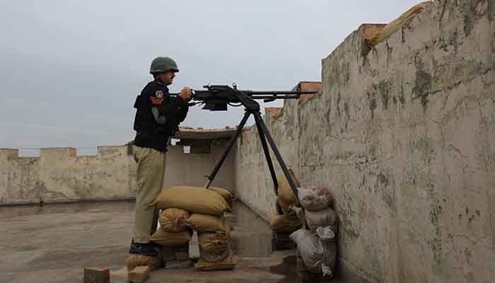 A police officer with a 12.7mm infantry machine gun takes position at Sarband Police Station’s rooftop, in the outskirts of Peshawar, Pakistan, February 9, 2023. — Reuters