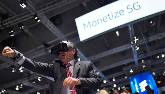 A visitor wears augmented reality (AR) glasses powered by 5G of Japanese e-sport technology company Hado at the Mobile World Congress (MWC), the telecom industry’s biggest annual gathering, in Barcelona. — AFP