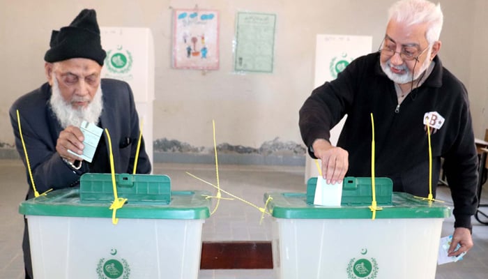 Two senior citizens cast their vote at a polling station during the second phase of Local Government (LG) Elections, held in Karachi. — PPI/File