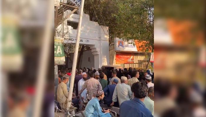 People queue outside SMB Fatima Jinnah Government Girls School in Karachis Garden area in District West for admission forms in this still taken from a video on March 7, 2023. — Twitter/@ZindagiTrust