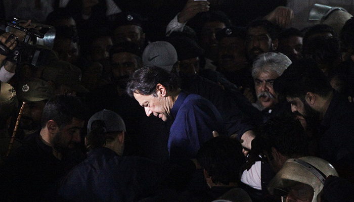 Former prime minister, Imran Khan, along with his supporters walks as he leaves the Lahore High Court in Lahore, on February 20, 2023. — Reuters