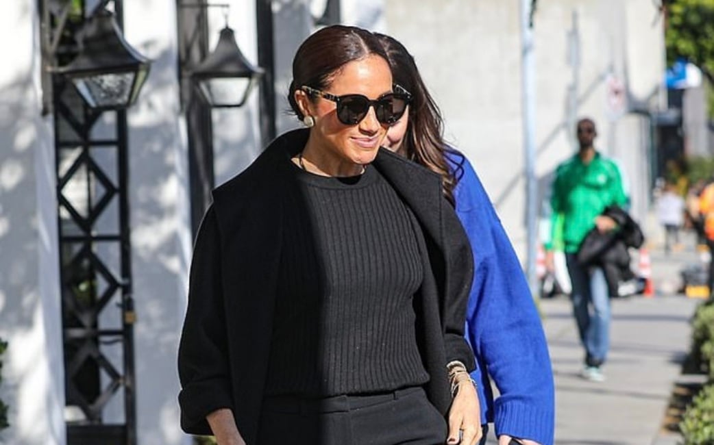 Meghan takes a stroll with a smug grin after getting what she wanted