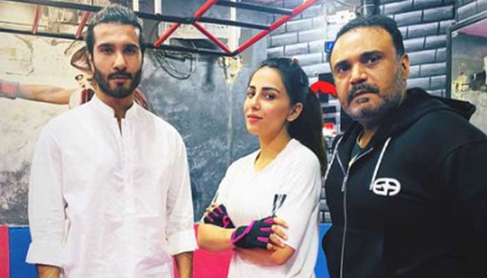 A screengrab of a picture showing Feroze Khan (left) and Ushna Shah (centre) with her gym instructor. — Instagram