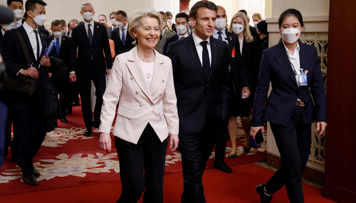 French President Emmanuel Macron (C) and European Commission President Ursula von de Leyen (L) arrive for a working session with Chinese President Xi Jinping in Beijing on April 6, 2023. — AFP