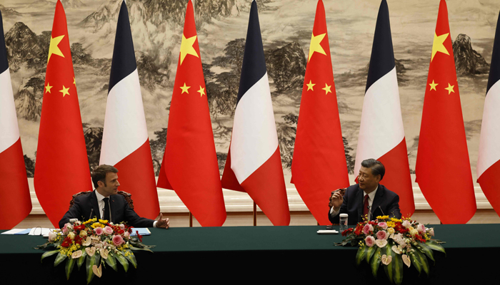 Chinas President Xi Jinping (R) and his French counterpart Emmanuel Macron attend a joint press conference in Beijing on April 6, 2023. — AFP