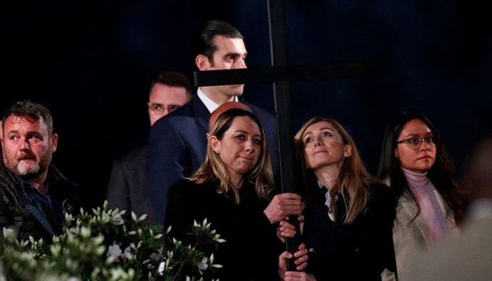 Ukrainian and Russian women carry a cross as they attend the Via Crucis (Way of the Cross) procession during Good Friday celebrations, at Colosseum, in Rome, Italy April 15, 2022. — Reuters