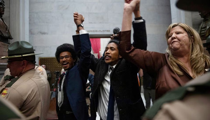 Rep. Justin Pearson, Rep. Justin Jones, and Rep. Gloria Johnson People hold their hands up as they exit the House Chamber doors at the Tennessee State Capitol Building, in Nashville, Tennessee, US. April 3, 2023. — Reuters