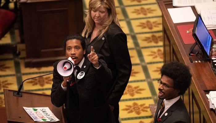 Tennessee State Representative Justin Jones, standing with Rep. Justin Pearson and Rep. Gloria Johnson, calls on his colleagues to pass gun control legislation from the well of the House Chambers during the legislative session, three days after the mass shooting at The Covenant School, at the State Capitol in Nashville, Tennessee, US March 30, 2023. — Reuters