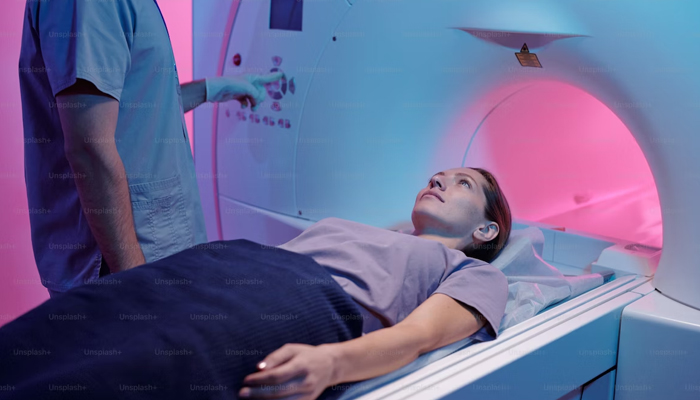 A representational image showing a woman going into MRI machine. — Unsplash/File