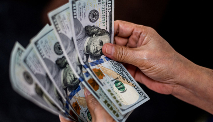 A person shows US currency notes at an exchange in Manila, Philippines on October 21, 2022. — Reuters/File